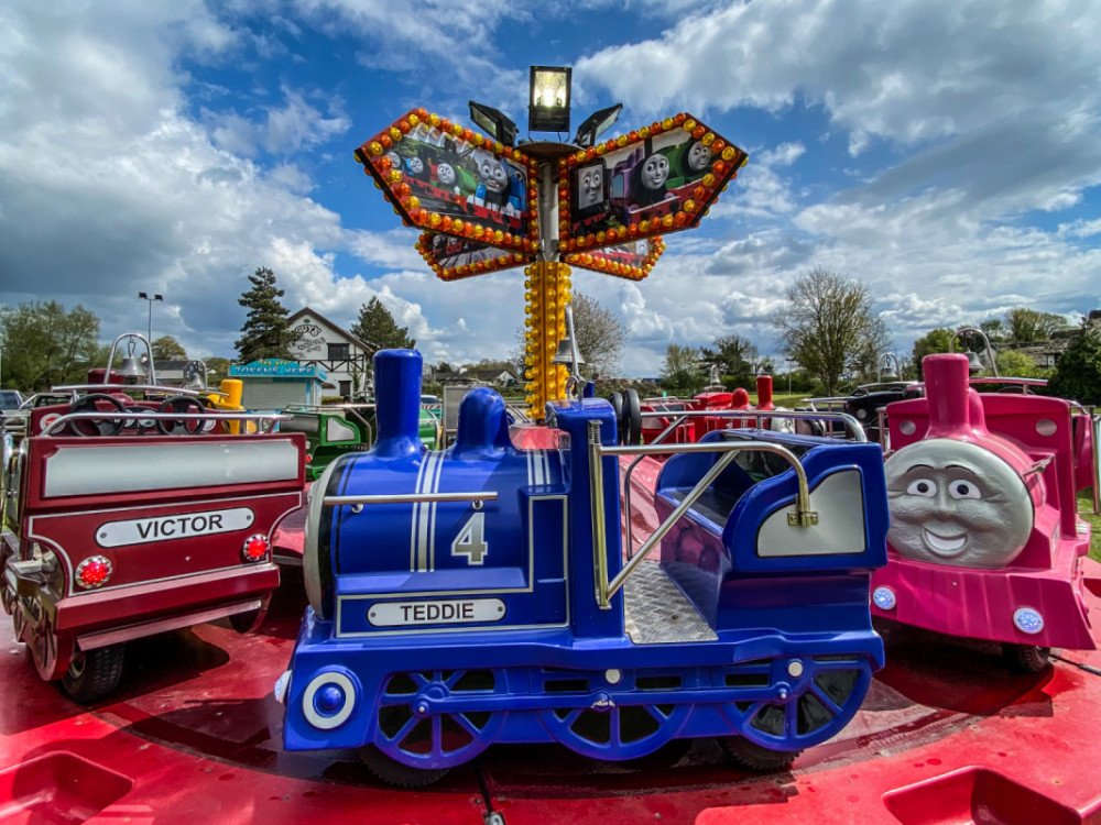 Kids fairgrounds rides with blue skies